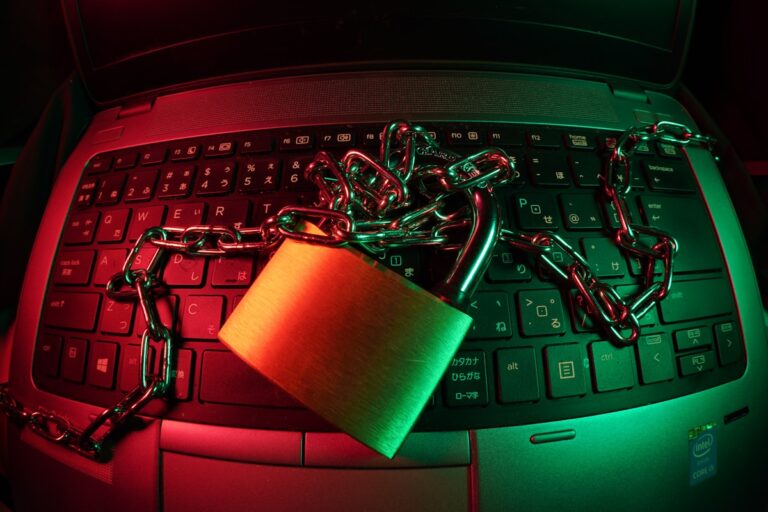 Padlock resting on a laptop keyboard, symbolizing password security for founders