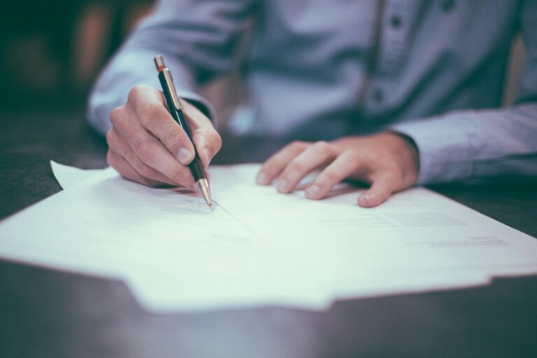 Fountain pen signing a contract on a desk