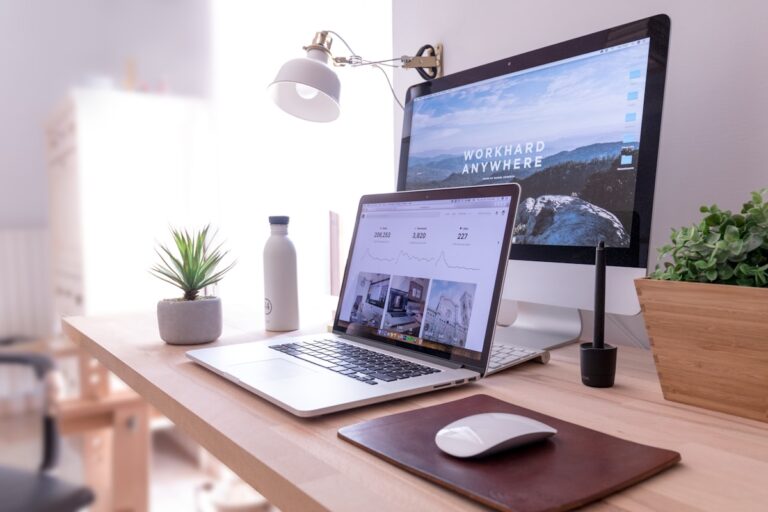 Laptop and coffee on a home office desk, a solo founder workspace for writing a paid newsletter