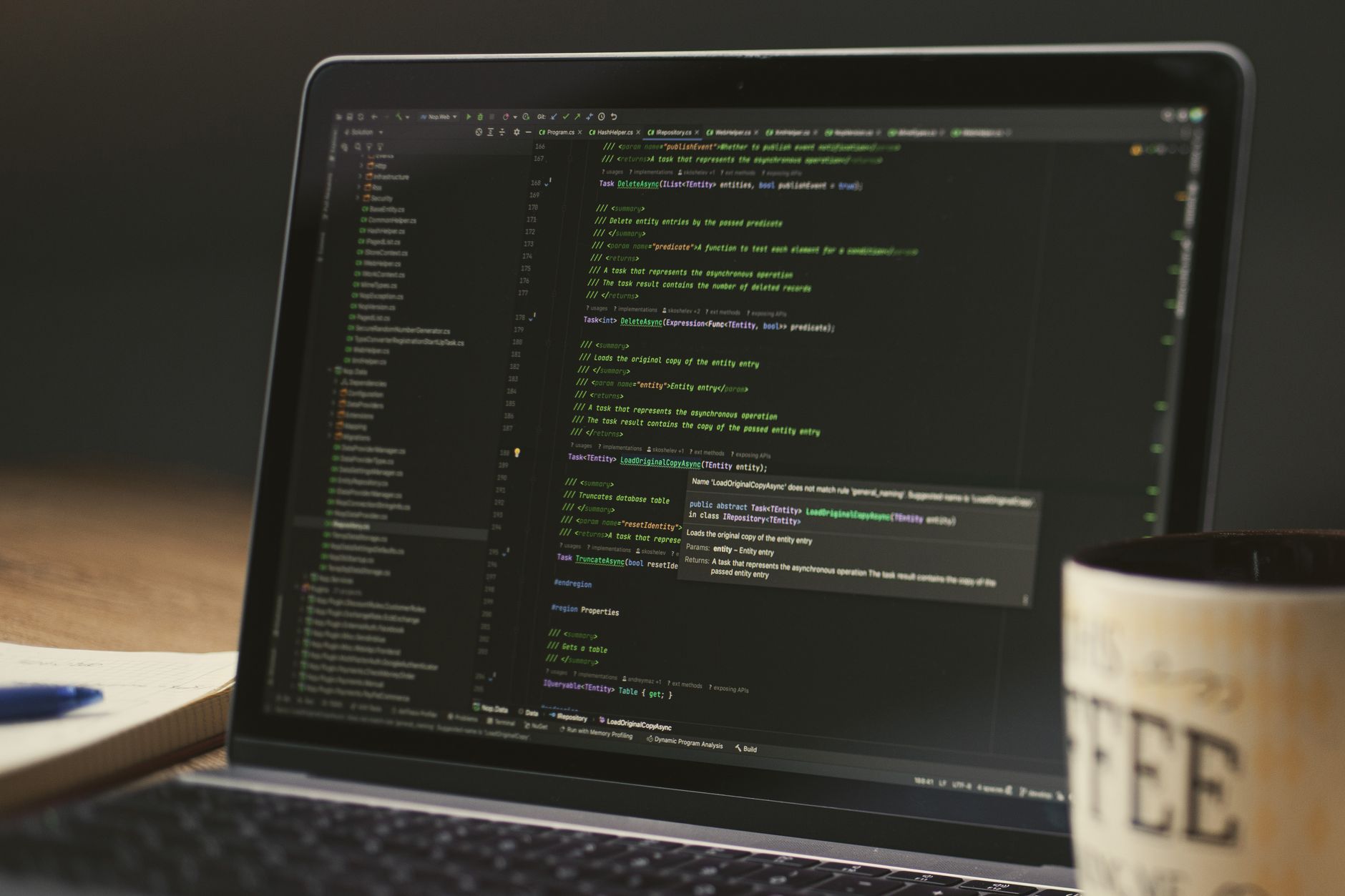 Dark laptop screen showing code at night, a local AI setup on a founder desk